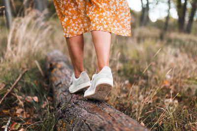 Low section of woman standing on ground