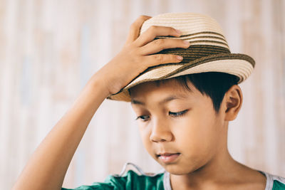 Close-up of boy wearing hat