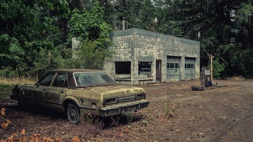 Old abandoned car on building