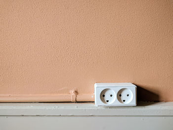 Close-up of electric plug on wall
