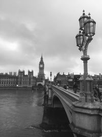 View of tower bridge over river against cloudy sky