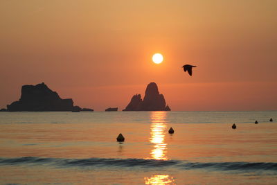 Scenic view of sea against orange sky