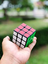 Close-up of person holding puzzle cube