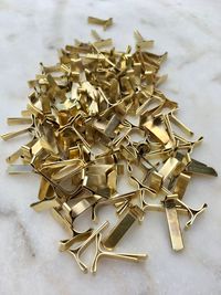 Close-up high angle view of golden metal on table