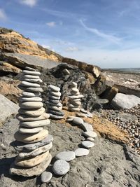 Stack of rocks on beach against sky