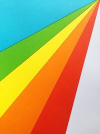 Low angle view of multi colored umbrella against blue sky