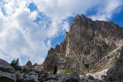 Low angle view of rocky mountains against sky