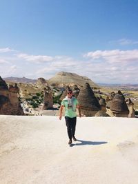 Full length of man standing on mountain against sky