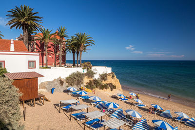 Scenic view of beach against blue sky