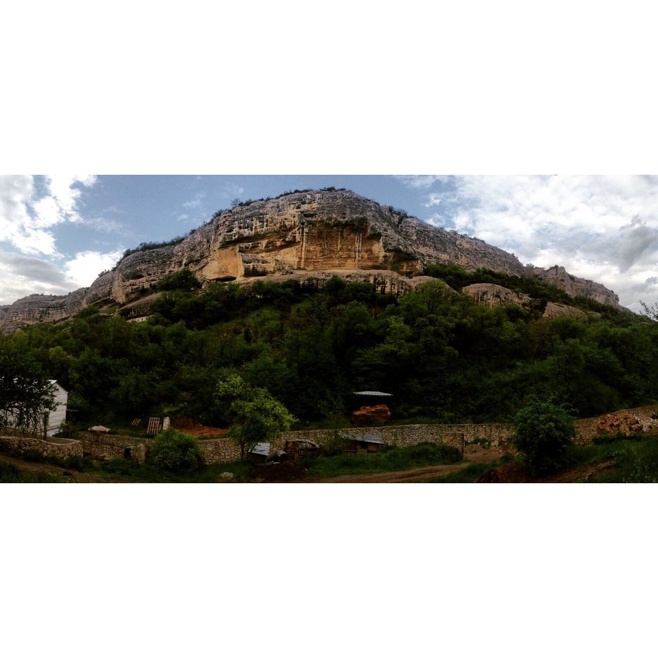 mountain, tranquil scene, scenics, tranquility, rock formation, beauty in nature, sky, landscape, nature, mountain range, transfer print, cliff, geology, rock - object, physical geography, rock, non-urban scene, rocky mountains, idyllic, tree