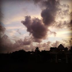 Built structure against cloudy sky at sunset