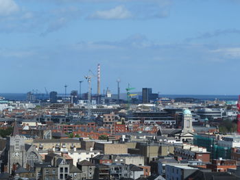 High angle view of buildings in town against sky