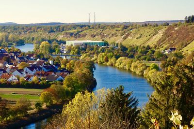 High angle view of river and trees against sky