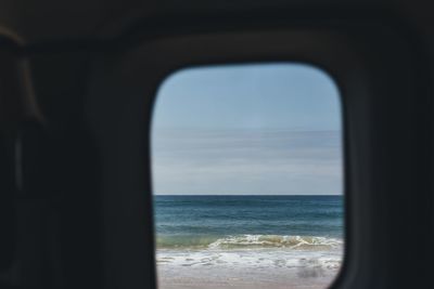 Scenic view of sea seen through window