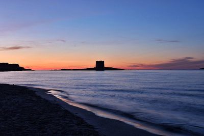 Scenic view of beach against sky during sunset