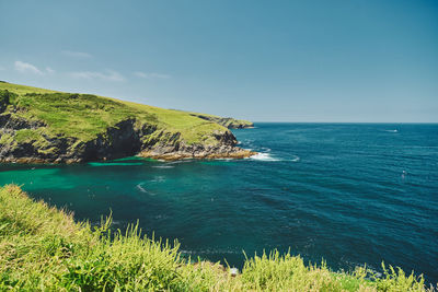 Scenic view of sea against sky at port isaac in cornwall, england