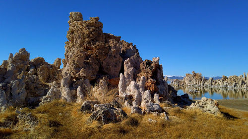 Low angle view of rock formation against clear sky