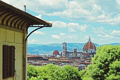 Houses against cloudy sky