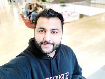 Portrait of smiling young man sitting outdoors