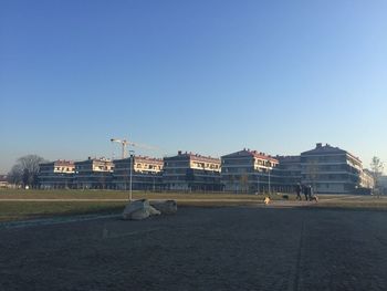 View of buildings against clear blue sky