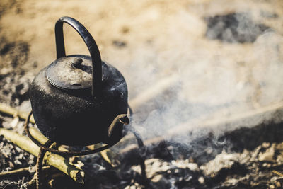 Metallic kettle emitting smoke