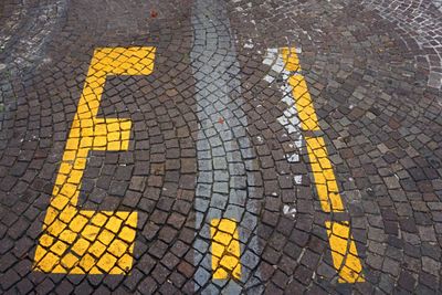 High angle view of arrow sign on road