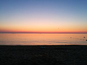 Scenic view of sea against clear sky during sunset