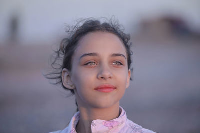 Close-up of thoughtful girl standing outdoors