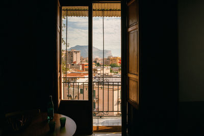 The view on the city with old buildings through the window and balcony, home, tranquil scene. 