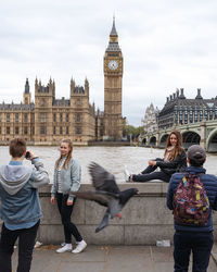 People on town square with clock tower in background