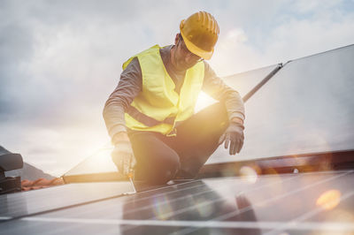 Low angle view of man standing against sky