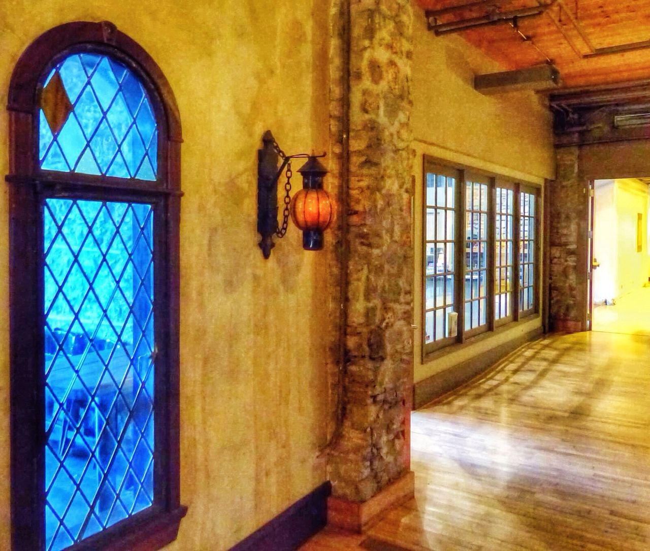 indoors, architecture, window, built structure, ceiling, low angle view, glass - material, home interior, transparent, house, day, no people, skylight, sunlight, wood - material, yellow, building, pattern, interior, door