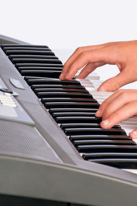 Midsection of person playing piano