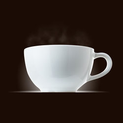 Close-up of coffee cup against black background