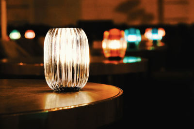 Close-up of illuminated light bulb on table in restaurant