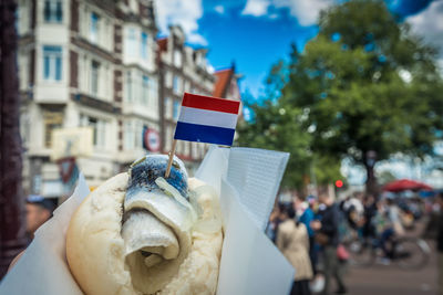 Close-up of flag in food against building