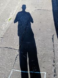 High angle view of man shadow on street