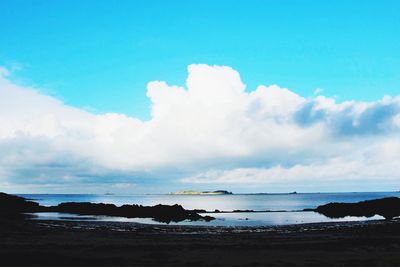 Scenic view of sea against cloudy sky