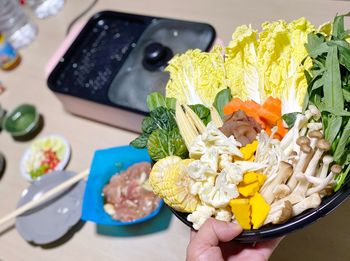 Close-up of person holding food in plate