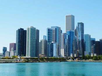 Tall buildings against clear sky with waterfront