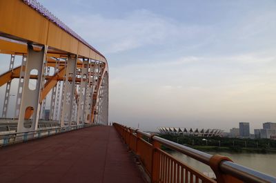 View of suspension bridge against cloudy sky