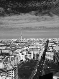 High angle view of buildings in city against cloudy sky