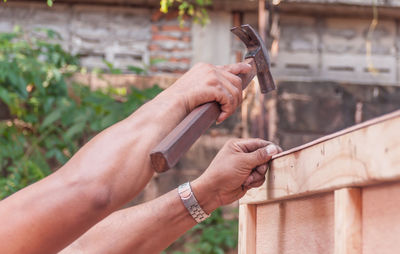 Close-up of hand hammering nail