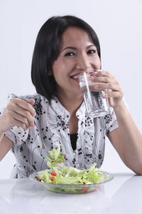 Portrait of smiling woman holding drink