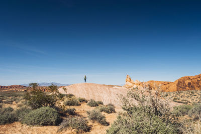 Scenic view of desert against clear blue sky