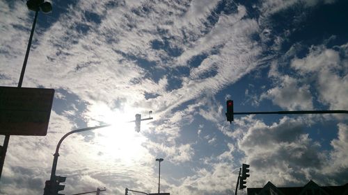 Low angle view of street light against cloudy sky