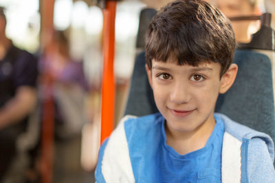 Portrait of happy boy sitting in tram