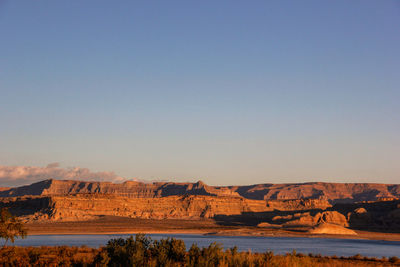 Scenic view of river against clear blue sky