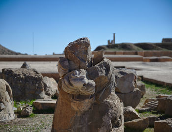 Stack of rocks on shore against clear sky