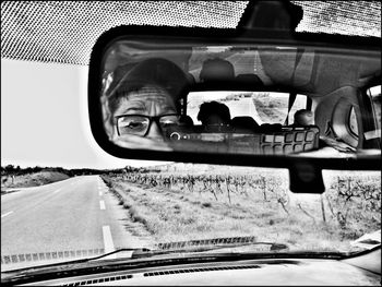 Portrait of man seen through car windshield